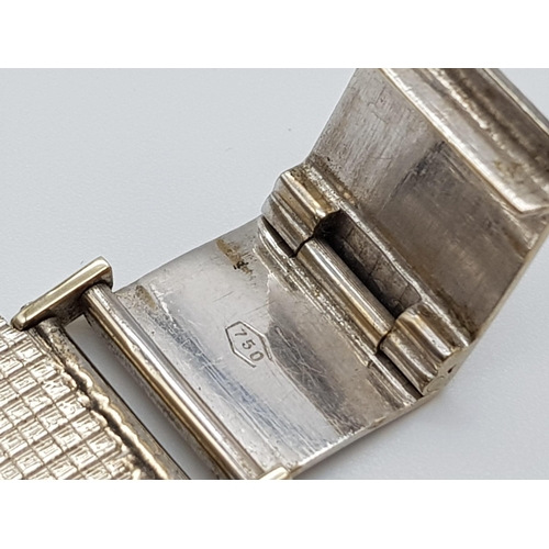 733 - A Piaget 18K White Gold Ladies Watch. 18k gold strap and square case - 26 x 26mm. Silver tone geomet... 