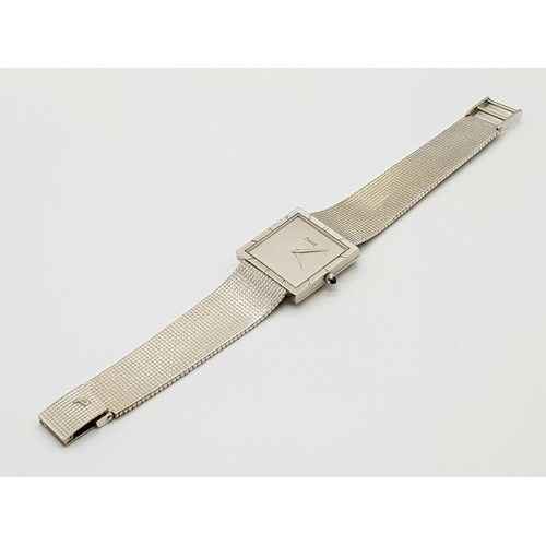 733 - A Piaget 18K White Gold Ladies Watch. 18k gold strap and square case - 26 x 26mm. Silver tone geomet... 