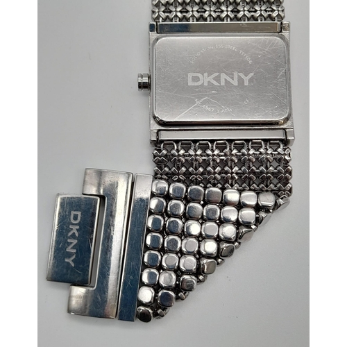 1190 - A LADIES DKNY WATCH ON A STAINLESS STEEL BRACELET  32 x 30mm