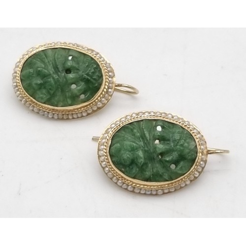 1075 - A vintage 14k yellow gold pair of earrings with carved oval jade surrounded by seed natural pearls. ... 