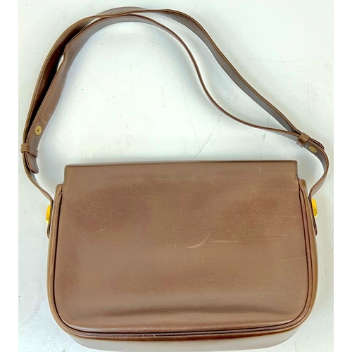 724 - A Brown Leather Gucci Horse-Bit Shoulder Bag. Gilded and bamboo hardware. Suede interior with zipped... 