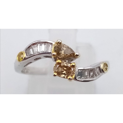 1032 - An 18K white gold twist ring with clear baguette and champagne round cut diamonds ((0.58 carats). Ri... 