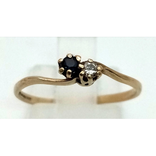 1558 - A Vintage 9K Yellow Gold Sapphire and Diamond Crossover Ring. Size M. 0.95g total weight.