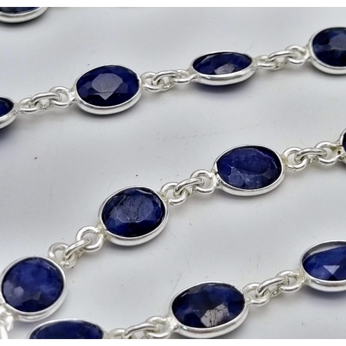 1524 - An Oval cut Blue Sapphire links Necklace set in 925 silver. Length: 83.5cm. Total weight: 27.71g