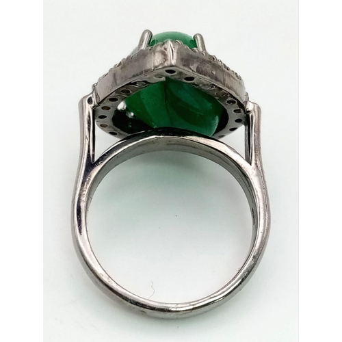 1544 - A 6.80ct Natural Emerald Cabochon Ring set in 925 silver and decorated with a 0.28ct Diamond accent ... 