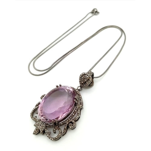 1655 - A 42.75ct Natural Oval cut Amethyst Pendant, set in 925 silver, decorated with a Diamond surround. C... 