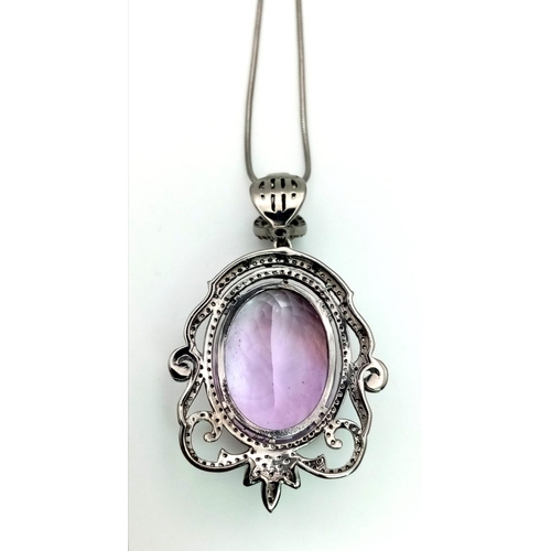 1655 - A 42.75ct Natural Oval cut Amethyst Pendant, set in 925 silver, decorated with a Diamond surround. C... 