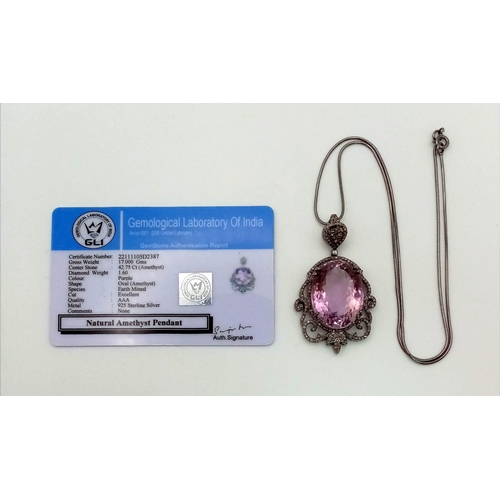 1655 - A 42.75ct Natural Oval cut Amethyst Pendant, set in 925 silver, decorated with a Diamond surround. C... 