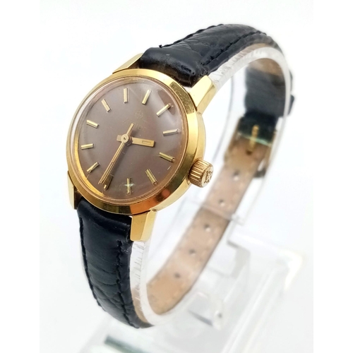 1341 - A ladies Zodiac watch with black leather strap.