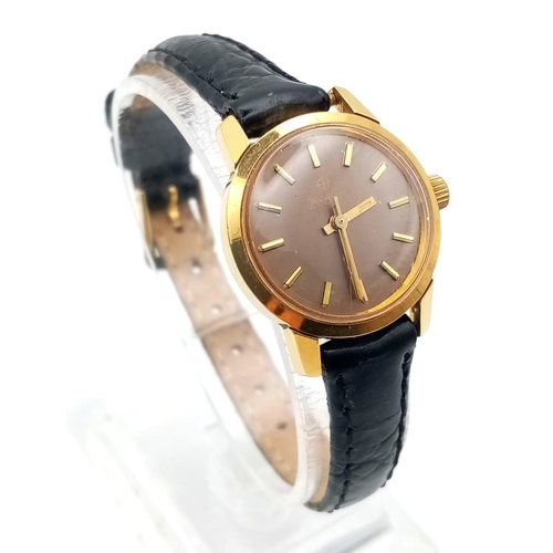 1341 - A ladies Zodiac watch with black leather strap.