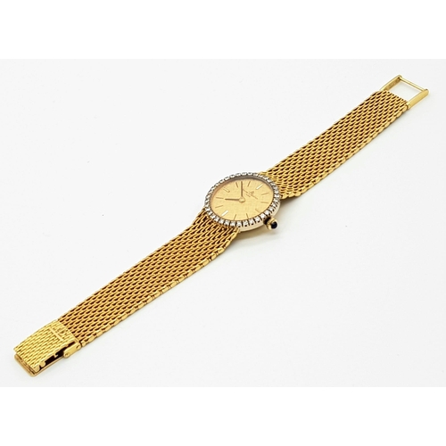 885 - A Baume and Mercier 18k Gold Ladies Watch. 18k Gold mesh strap and case - 25mm. Gold tone dial with ... 