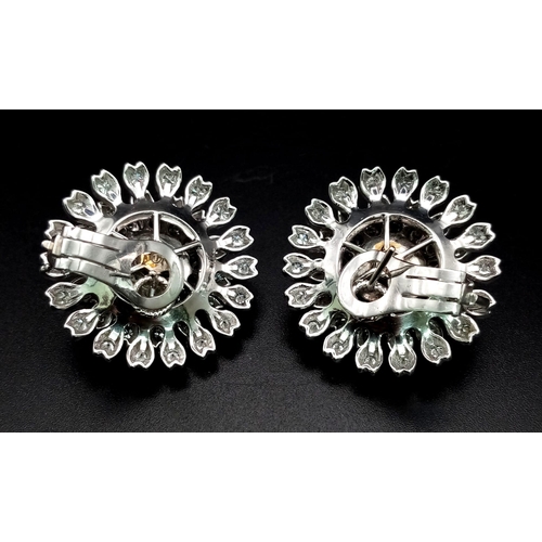 730 - A Pair of 18K White Gold 7.5ct Diamond Earrings. Floral circular design with brilliant round cut dia... 