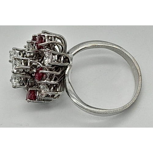 381 - An 18K White Gold Diamond and Ruby Ring. Floral design with ten brilliant round cut diamonds - 2.5ct... 