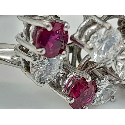 381 - An 18K White Gold Diamond and Ruby Ring. Floral design with ten brilliant round cut diamonds - 2.5ct... 