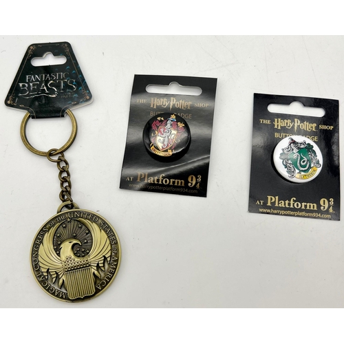 1042 - A huge collection of Harry Potter and Fantastic Beasts badges and keyrings, all houses included.