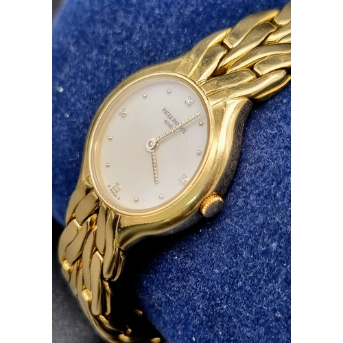 271 - A Patek Phillipe 18k Gold Ladies Watch. 18k gold strap and case - 22mm. White dial with diamonds on ... 