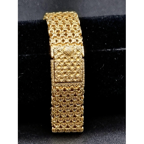 31 - A Patek Phillipe 18K Gold and Diamond Ladies Dress Watch. 18k gold mesh bracelet. Gold and diamond b... 