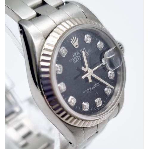 389 - A Rolex Oyster Perpetual Datejust Ladies Watch. Stainless steel strap and case - 26mm. Black dial wi... 