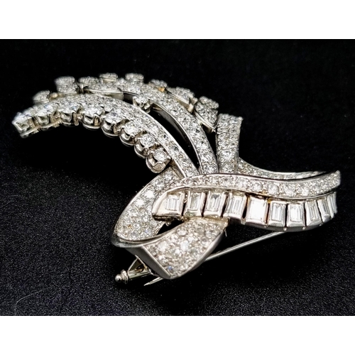 44 - A 6ct Diamond and Platinum Bow Brooch. Brilliant cut baguette, round cut and encrusted diamonds crea... 