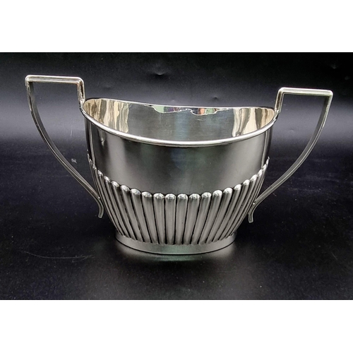 662 - A SOLID SILVER HALF FLUTED ART DECO TEA SET WITH TEA POT, SUGAR BOWL AND CREAMER IN LOVELY CONDITION... 