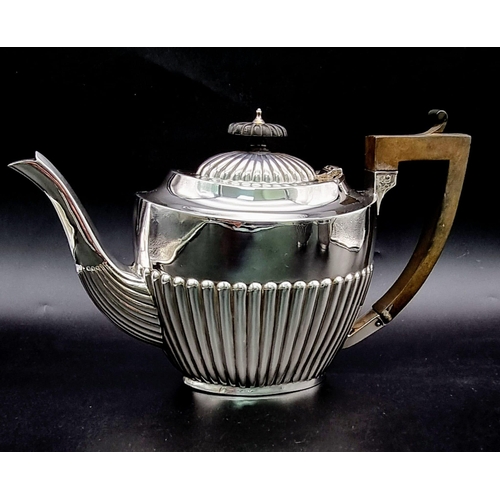 662 - A SOLID SILVER HALF FLUTED ART DECO TEA SET WITH TEA POT, SUGAR BOWL AND CREAMER IN LOVELY CONDITION... 