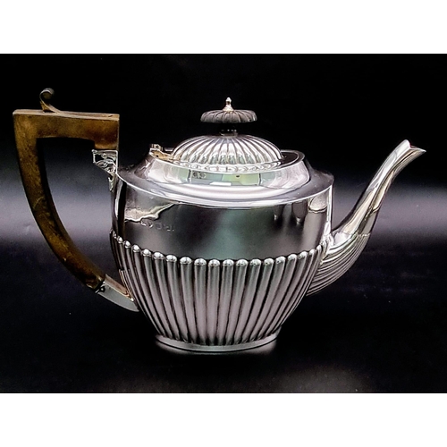 662 - A SOLID SILVER HALF FLUTED ART DECO TEA SET WITH TEA POT, SUGAR BOWL AND CREAMER IN LOVELY CONDITION... 