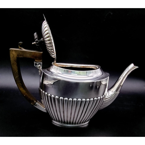 662 - A SOLID SILVER HALF FLUTED ART DECO TEA SET WITH TEA POT, SUGAR BOWL AND CREAMER IN LOVELY CONDITION... 