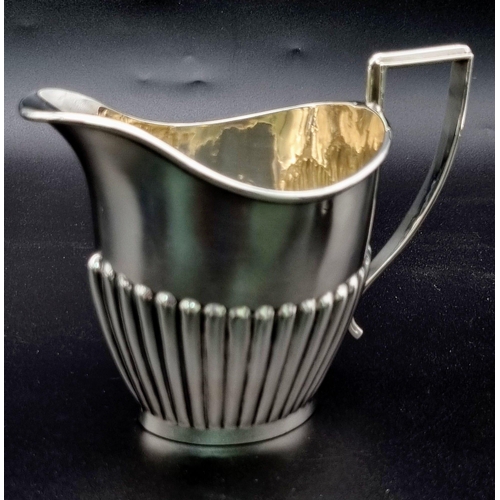 662 - A SOLID SILVER HALF FLUTED ART DECO TEA SET WITH TEA POT, SUGAR BOWL AND CREAMER IN LOVELY CONDITION... 