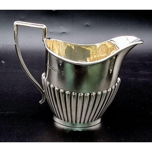 662 - A SOLID SILVER HALF FLUTED ART DECO TEA SET WITH TEA POT, SUGAR BOWL AND CREAMER IN LOVELY CONDITION... 