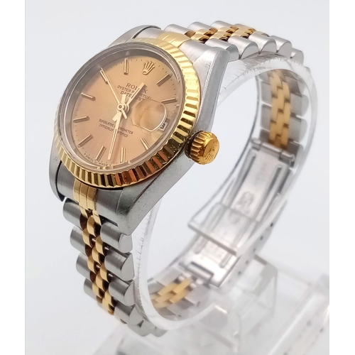 239 - A Rolex Oyster Perpetual Datejust Ladies Watch. Bi-metal jubilee strap and case - 26mm. Gold tone di... 