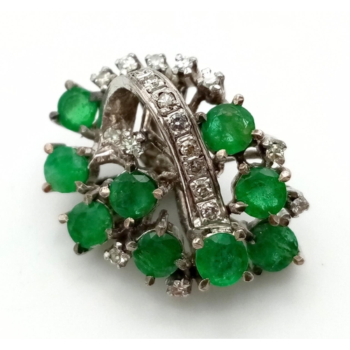 380 - A Vintage Emerald and Diamond Pendant set in Platinum. Nine emeralds and twenty diamonds in a heart-... 