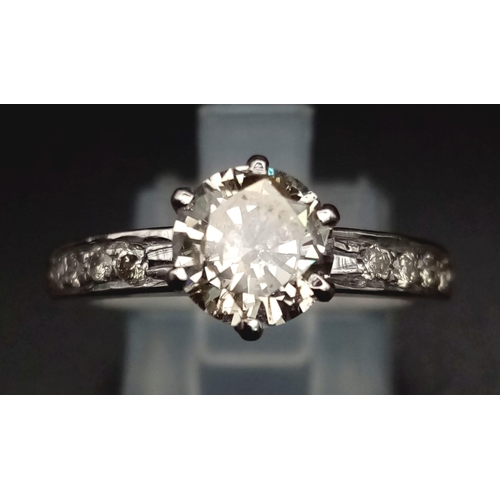 86 - A Diamond Solitaire Platinum Ladies Ring. 0.90ct brilliant light yellow round cut central diamond. F... 