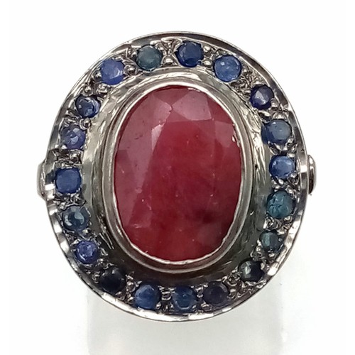 987 - A Ruby (6.3ct) Ring with Blue Sapphire Surround. 925 Sterling Silver - oxidised effect. Size N/O. Co... 