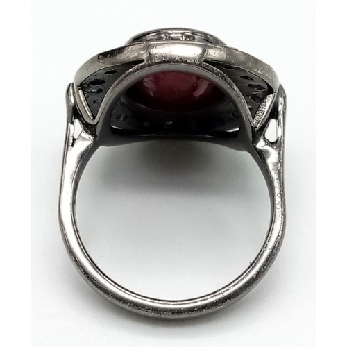 987 - A Ruby (6.3ct) Ring with Blue Sapphire Surround. 925 Sterling Silver - oxidised effect. Size N/O. Co... 