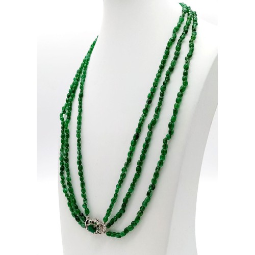 332 - A 165ct Rare Triple Strand Emerald Necklace. 37g. 44-54cm.
Silver and emerald clasp.