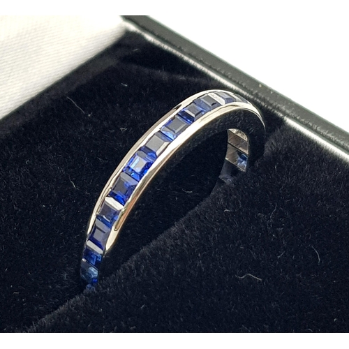 299 - A 18k White Gold Full Eternity Band with Channel Set Square Blue Sapphires. Approx. 4ct of Sapphires... 