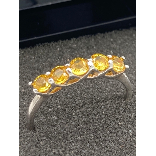 378 - SILVER and TOPAZ RING having a sweep of five yellow Topaz mounted to top. 
 Size Q 1/2. Presented in... 