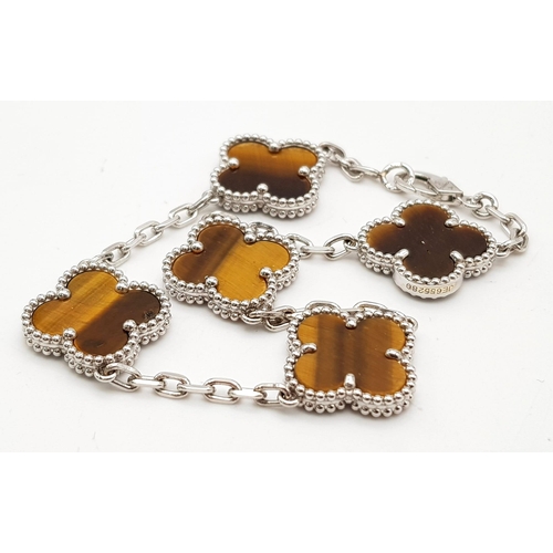 426 - A Van Cleef and Arpels Alhambra bracelet with 5 motifs - 18ct white gold with tigers eye inserts. Le... 