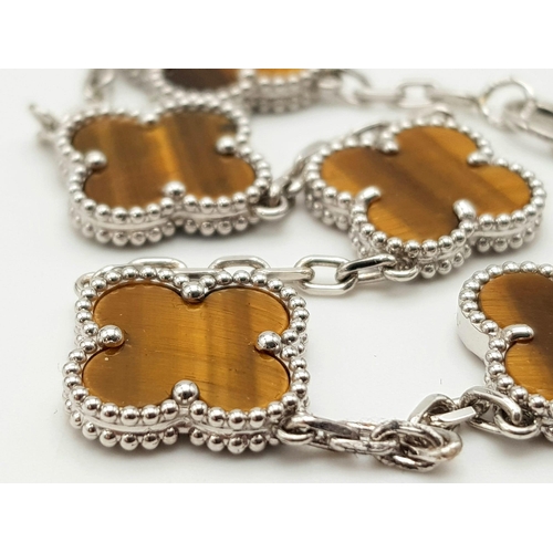 426 - A Van Cleef and Arpels Alhambra bracelet with 5 motifs - 18ct white gold with tigers eye inserts. Le... 