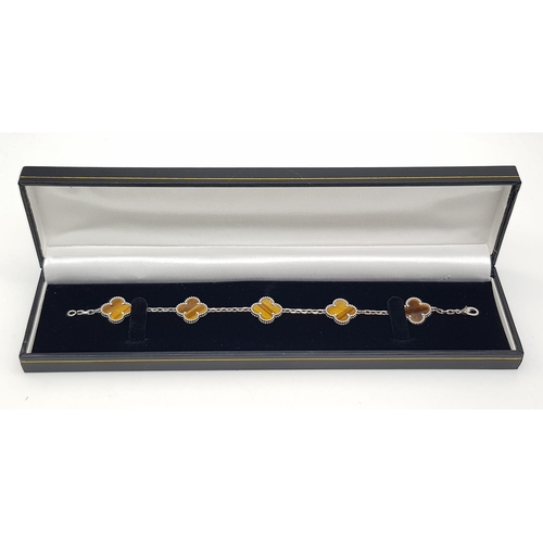 426 - A Van Cleef and Arpels Alhambra bracelet with 5 motifs - 18ct white gold with tigers eye inserts. Le... 