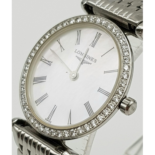 572 - A Longines Ladies Grande Classique Watch. Stainless steel strap and case - 25mm. Diamond bezel. Whit... 