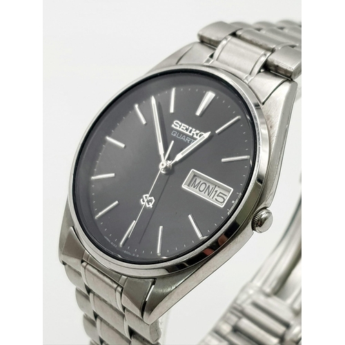 632 - A SEIKO QUARTZ WATCH IN STAINLESS STEEL WITH DAY/DATE BOX AND ATTRACTIVE BLACK DIAL.   34mm