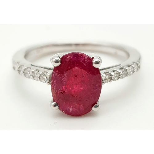 690 - 9K WHITE GOLD DIAMOND & RUBY RING WITH 1.75CT OVAL RUBY CENTRE AND  0.15CT DIAMONDS SET ON BOTH SIDE... 