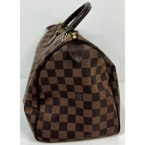 143 - A Louis Vuitton Monogram Canvas and Leather Checked Small Tote Bag. Gilded hardware. Red interior. 2... 