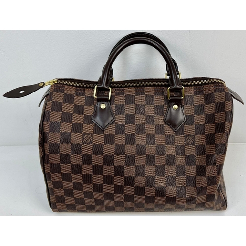 143 - A Louis Vuitton Monogram Canvas and Leather Checked Small Tote Bag. Gilded hardware. Red interior. 2... 