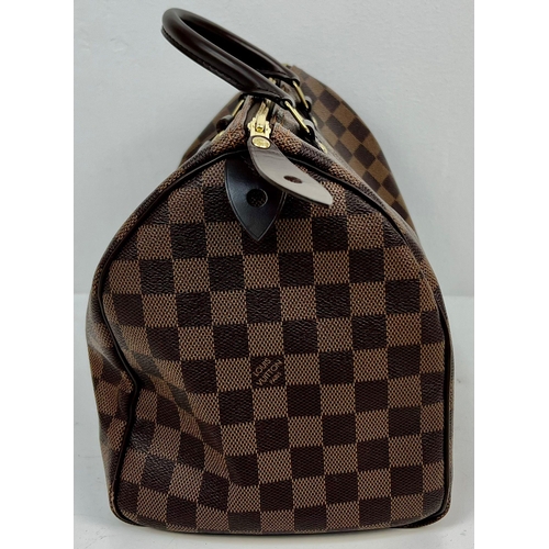 143 - A Louis Vuitton Monogram Canvas and Leather Checked Small Tote Bag. Gilded hardware. Red interior. 2... 