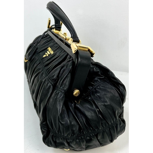 220 - A Prada Black Gaufre Large Leather Hand Bag. Gilded hardware. Zipped inner compartment. 42 x 25cm. R... 