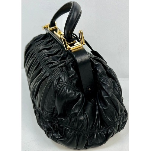 220 - A Prada Black Gaufre Large Leather Hand Bag. Gilded hardware. Zipped inner compartment. 42 x 25cm. R... 