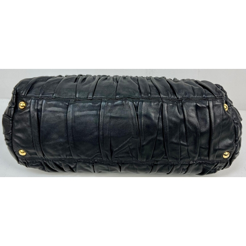 220 - A Prada Black Gaufre Large Leather Hand Bag. Gilded hardware. Zipped inner compartment. 42 x 25cm. R... 