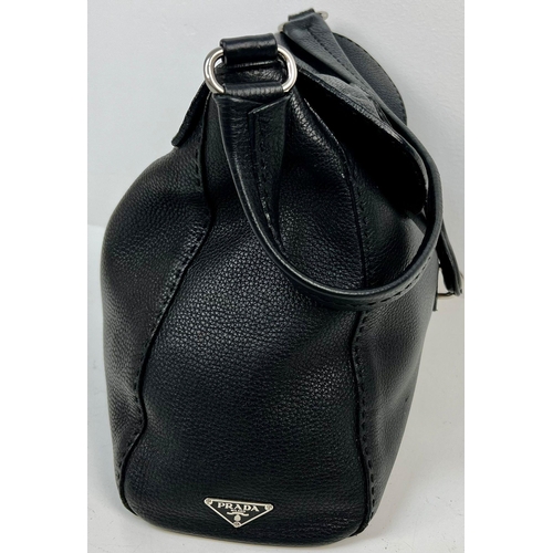 401 - A Large Prada Black Leather handbag with Hook Clasp. Monogram interior with zipped compartment. 30 x... 